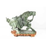 A large Chinese carved soapstone horse on hardwood stand, 48 by 20 by 42cm high including stand.