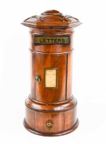 A 19th century treen table top post box, circa 1880, labelled 'letters', and the curved door