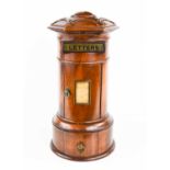 A 19th century treen table top post box, circa 1880, labelled 'letters', and the curved door
