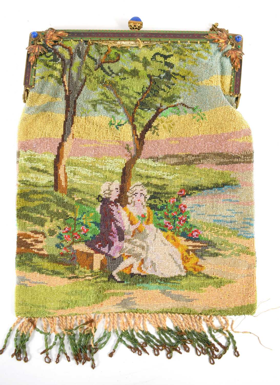 An antique micro beaded ladies purse, depicting a courting couple sat under a tree, the gilt metal