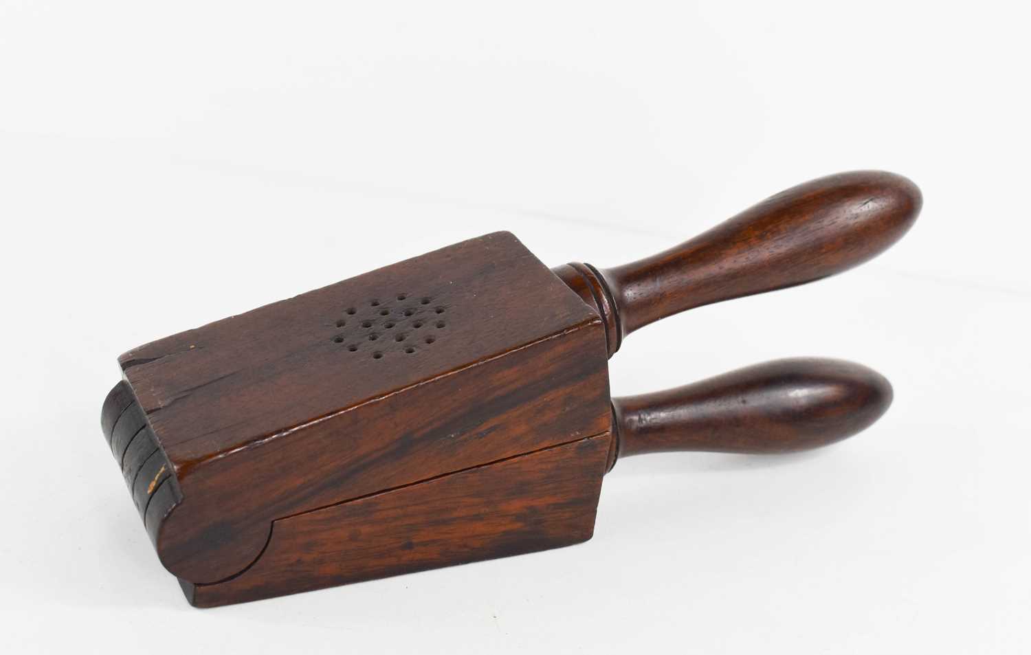 A treen fruit press, likely rosewood, the two turned handles adjoin the hinged blocks, one side with - Image 2 of 3