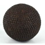 An antique nail studded boule ball, 11cm high.