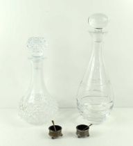 Two crystal glass decanters, one having a floral and spiral pattern, together with a pair of