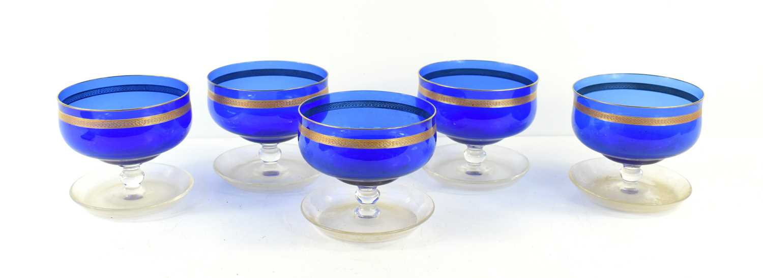 Five Art Nouveau blue glass dessert bowl with copper rims and applied copper engraved bands. [