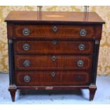 A 19th century French chest of drawers with a stepped front housing four graduated drawers flanked