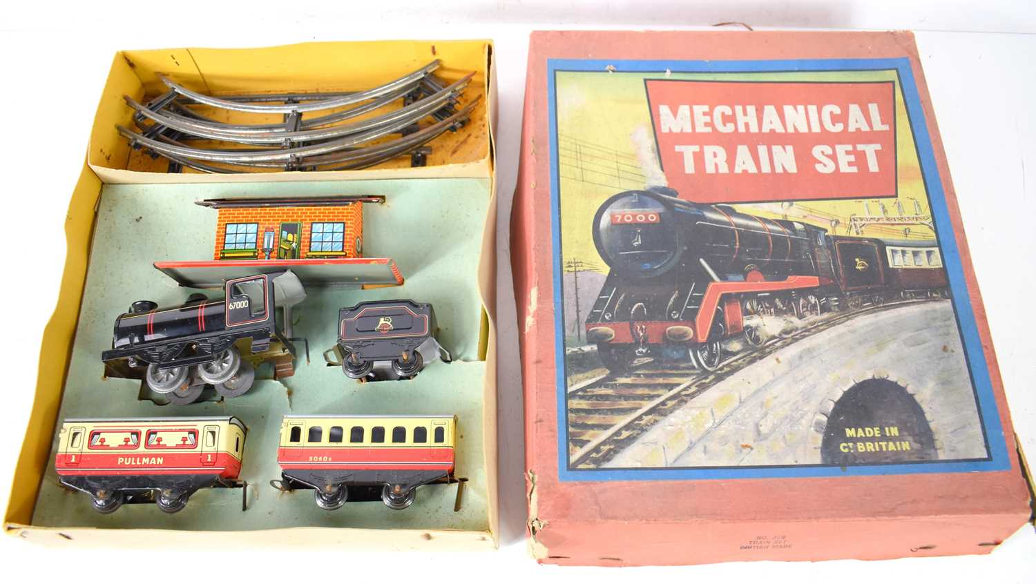 A vintage mechanical tin plate train set, British made, with Pullman carriages, locomotive,