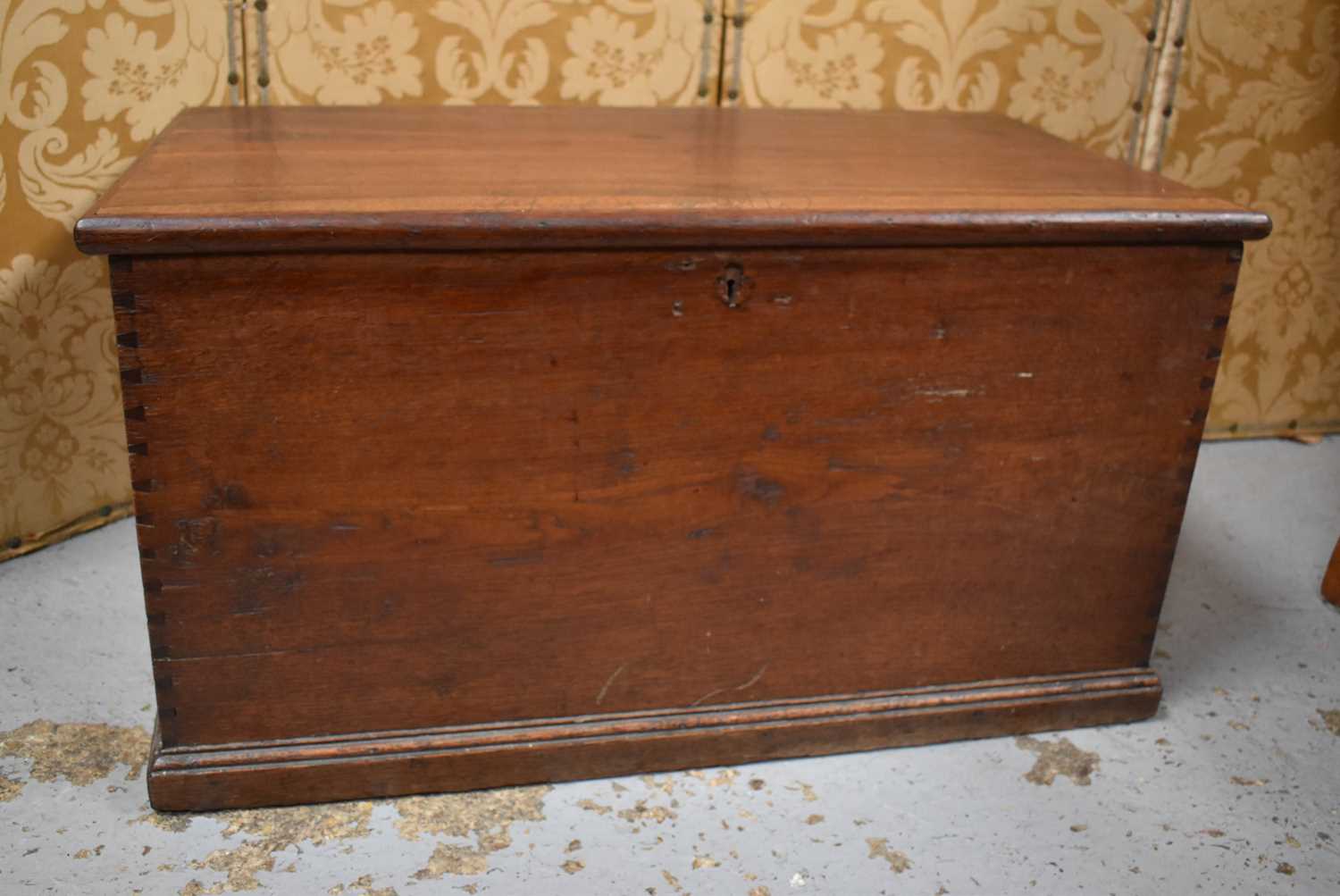 A late 19th century oak blanket chest with iron hinges, the interior lined with copies of the