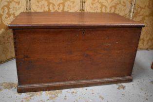 A late 19th century oak blanket chest with iron hinges, the interior lined with copies of the