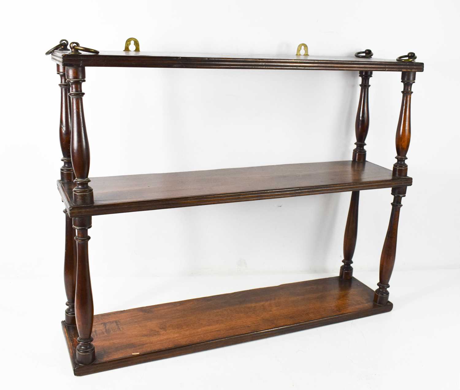 A 19th century oak wall shelf, composed of three reeded shelves united by baluster turned