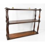 A 19th century oak wall shelf, composed of three reeded shelves united by baluster turned