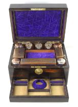 A 19th century coromandel vanity case, fully fitted interior lined in purple velvet, and housing