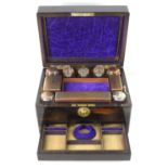 A 19th century coromandel vanity case, fully fitted interior lined in purple velvet, and housing