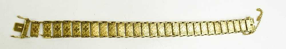 A 9ct gold twenty eight panelled bracelet, each rectangular panel with engraved floral decoration,