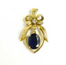 An 18ct gold diamond and sapphire pendant, the oval sapphire of approximately 10.8 by 8.5mm,