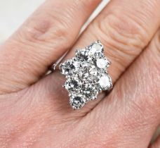 A diamond dress ring, set with nine brilliant cut diamonds, the central stone of approximately 0.