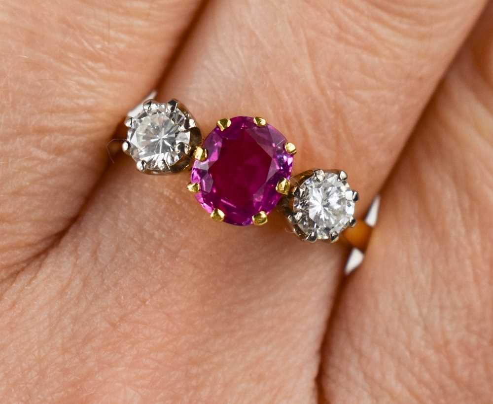 A 9ct gold, diamond and pink sapphire ring, the central sapphire approximately 1ct, the flanking