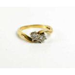 A 9ct gold and diamond illusion set crossover ring, each diamond of approximately 0.1ct, size Q, 3.