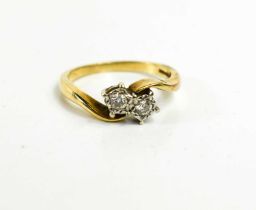 A 9ct gold and diamond illusion set crossover ring, each diamond of approximately 0.1ct, size Q, 3.