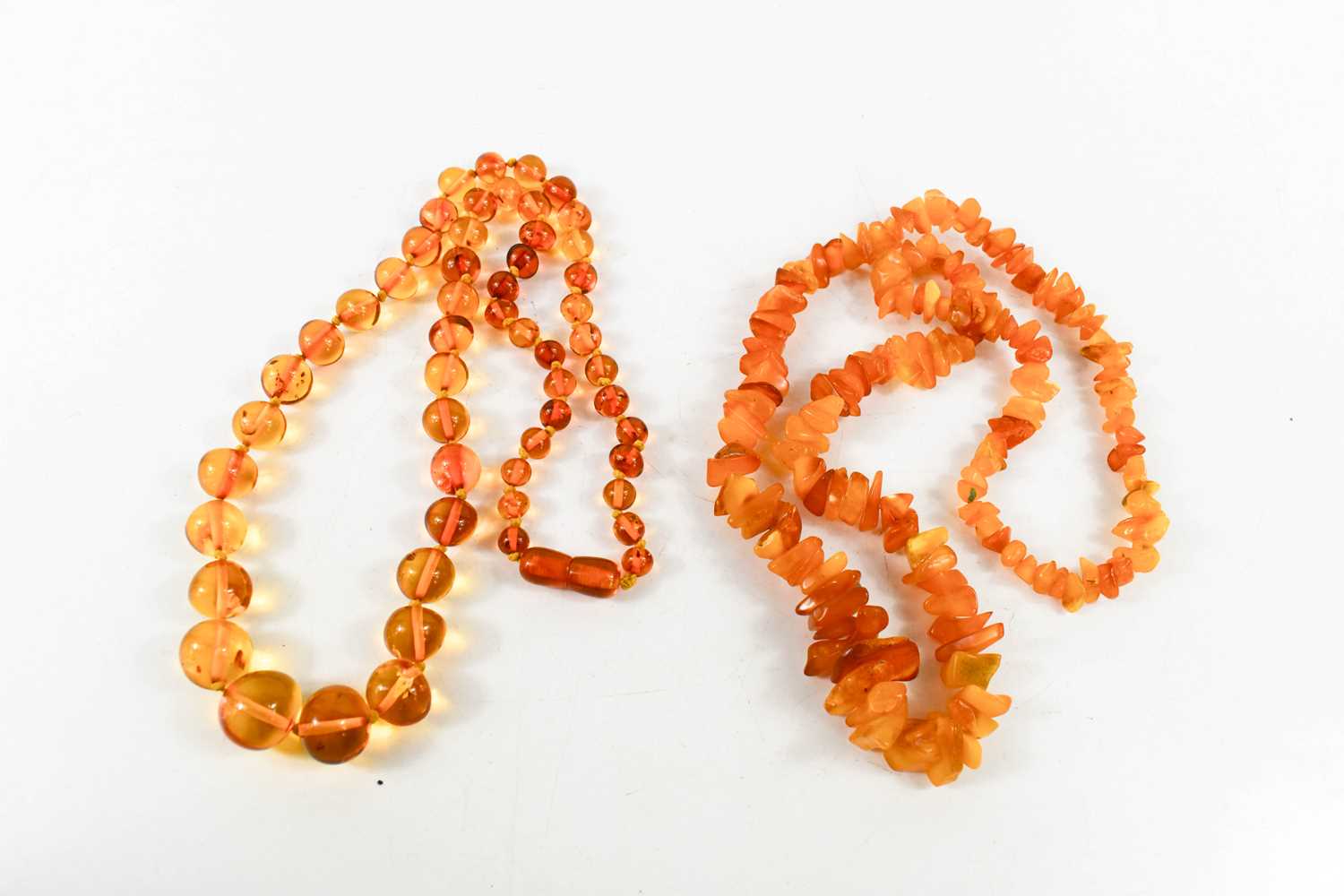 Two vintage amber beaded necklaces, one of rough cut graduated form, 37g, the other of clear hand