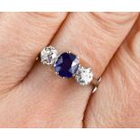 An 18ct white gold, diamond and sapphire ring, the two diamonds 0.3ct each, the cornflower blue