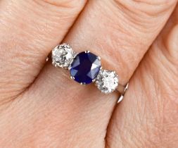 An 18ct white gold, diamond and sapphire ring, the two diamonds 0.3ct each, the cornflower blue