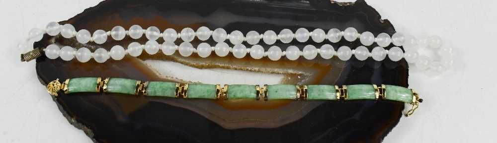 A white jade bead necklace, 50cm long, 37.8g, and a jade and silver gilt bracelet, 18cm long, 14.