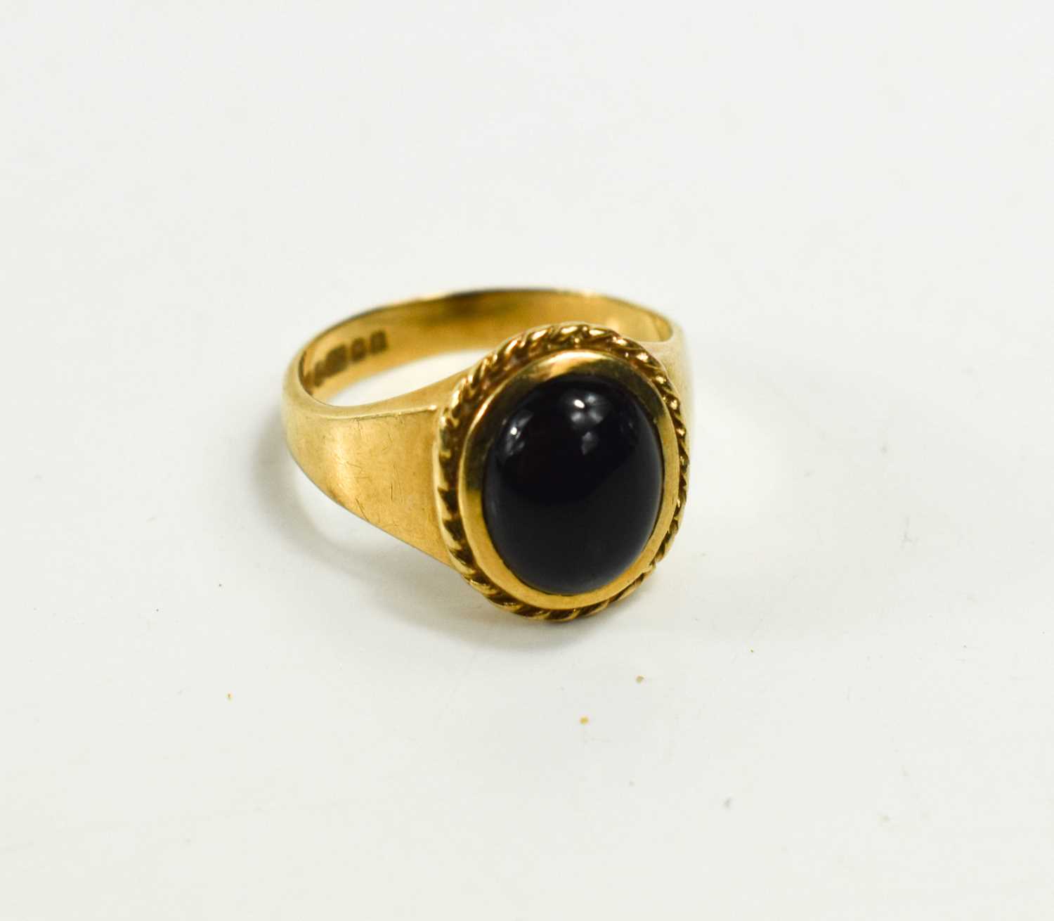 A 9ct gold ring set with an oval dark cabochon stone, size L, 4.09g.