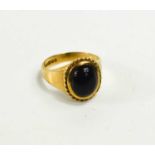 A 9ct gold ring set with an oval dark cabochon stone, size L, 4.09g.