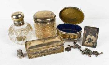 A group of silver to include a silver footed trinket box with repousse finish, a silver thimble,