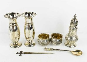 A group of silver to include a pair of silver embossed salts, a pair of silver bud vases Sheffield