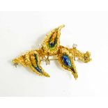 An 18ct gold, diamond and enamel brooch, in a modernist foliate form, composed of three 'leaves'