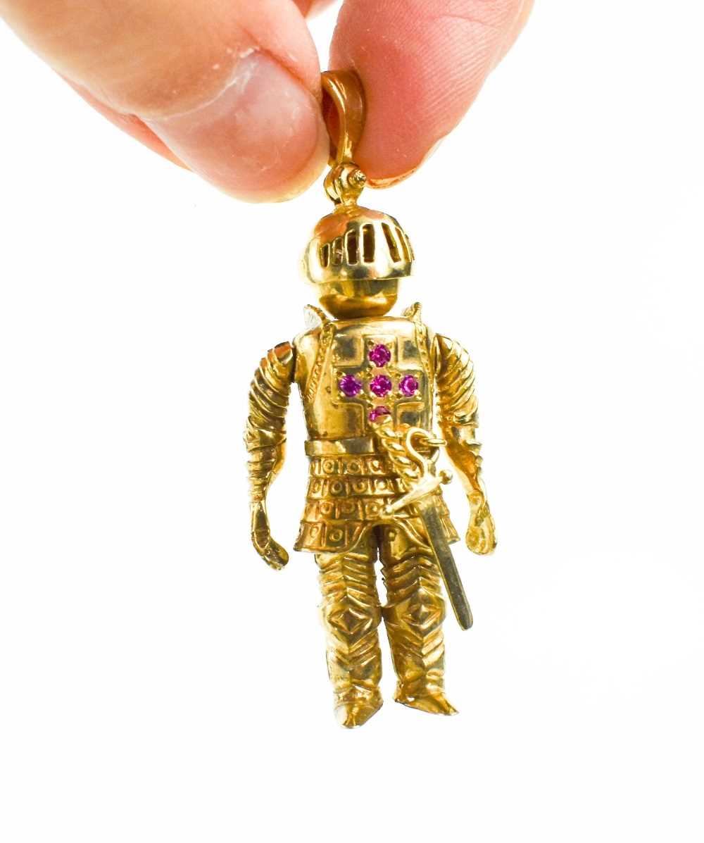 A 9ct gold knight pendant, the articulated form with five stone ruby cross to the breast-plate, 54. - Image 3 of 3