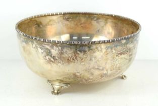 A white metal fruit bowl with gadrooned rim, on three cast feet, hallmark to underside, 23cm