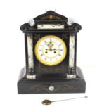 A French slate and marble mantle clock, carved floral decoration, visible escapement, with pendulum,