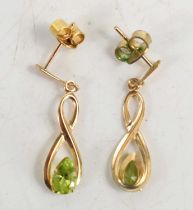 A pair of 9ct gold and peridot drop earrings.