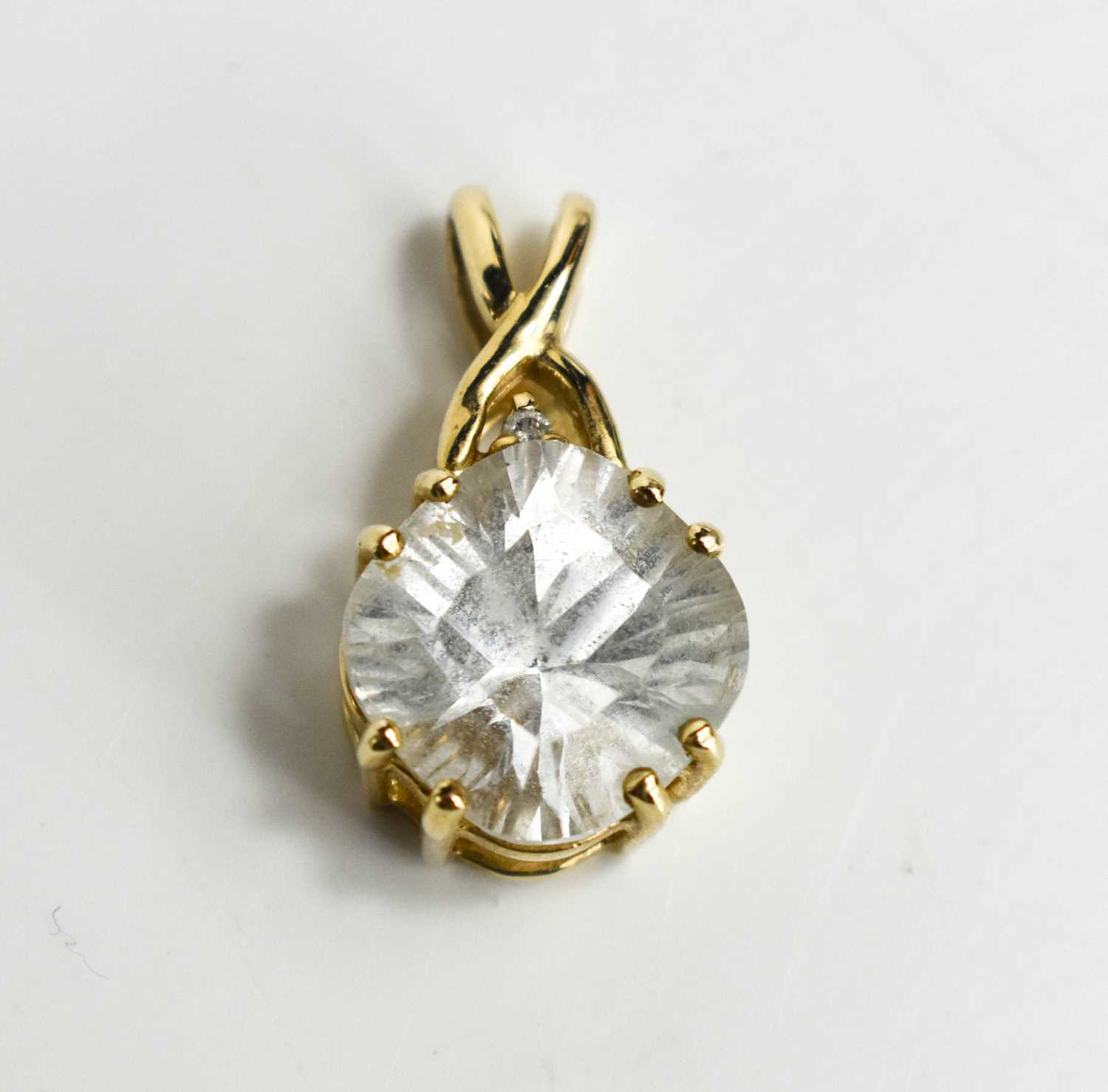 A glacier topaz and diamond pendant, the topaz of approximately 10.7mm diameter, with diamond