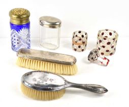 A silver handled hair and clothes brush together with a cobalt blue glass sugar sifter and other