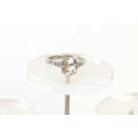 An old brilliant cut solitaire diamond and platinum ring, the diamond of very slightly uneven