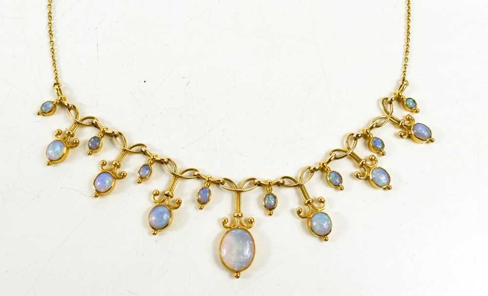 A gold and opal necklace, set with graduated links of opal cabochons, the chain link necklace having - Image 2 of 2