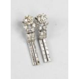 A pair of Art Deco18ct white gold and diamond drop earrings, each of the primary diamonds