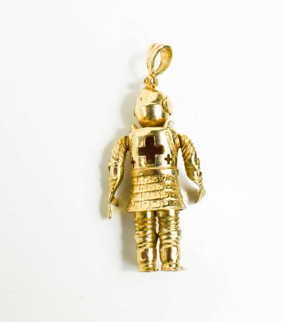 A 9ct gold knight pendant, the articulated form with five stone ruby cross to the breast-plate, 54. - Image 2 of 3