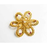 A gold (testing as at least 14ct) diamond and pink sapphire set flower head form brooch, with