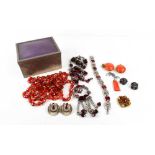 A group of Art Deco and later costume jewellery in red tones, including a tangerine orange