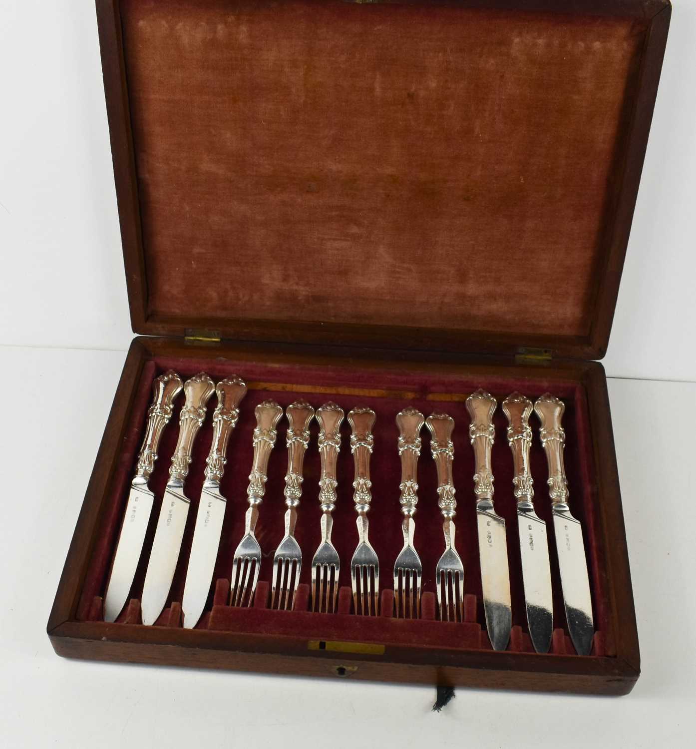 A 19th century set of silver handled knives and forks, six of each, in the original mahogany