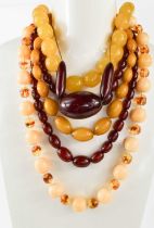 A group of six vintage faux amber necklaces, comprising two of graduated cherry coloured Bakelite