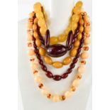 A group of six vintage faux amber necklaces, comprising two of graduated cherry coloured Bakelite