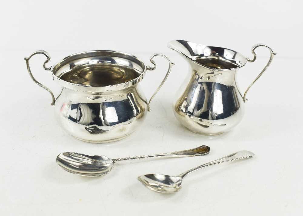 An Art Deco silver sugar bowl and jug, with auricula handles, both by S. Blankensee and Son Ltd, one