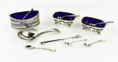 A group of silver items comprising a pair of salts, with pierced foliate decoration, a single