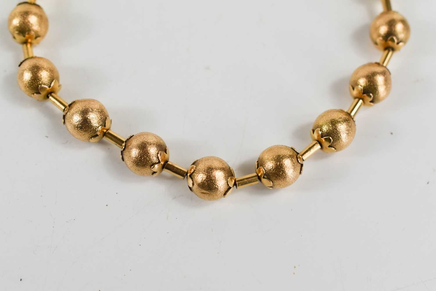 A Victorian gold bracelet of ball and bar form, each ball textured with flower finial to either end, - Image 3 of 3