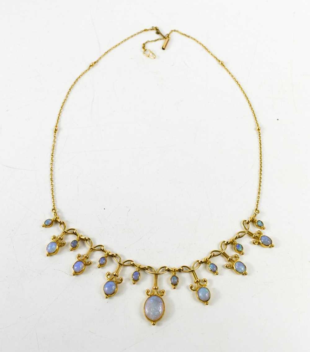 A gold and opal necklace, set with graduated links of opal cabochons, the chain link necklace having